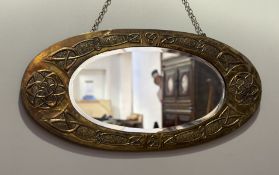 An Arts and Crafts possiby Glasgow School, celtic knot embrossed framed oval hall mirror. (