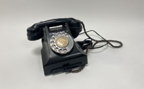 A mid 20thc black bakelite rotary call exchange telephone with spin dial, bearing 'Grange 2239' to