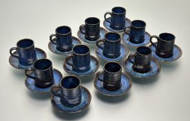 A Studio Stoneware by S.Kalpn set of fifteen coffee cups and fiffteen saucers, in a brown and blue