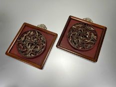 A pair of relief hand carved Chinese wooden wall panels with gilt wooden birds and foliate
