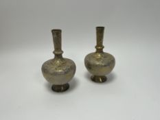 A pair of early 20thc Indian brass vases of bulbous form, etched with figures and foliate detail