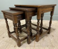 A set of 20th century Jacobean style oak nesting tables, with rectangular top over turned shaped
