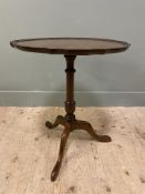 An Edwardian mahogany wine table, in the George III style, with circular top and pie-crust edge,