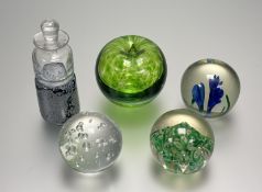 A collection of paperweights comprising, a paperweight with a blue iris's, one in the form of a