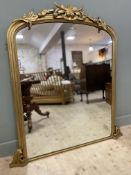 A Victorian gilt-wood overmantle mirror, with foliate leaf carved detail to top, over an arched