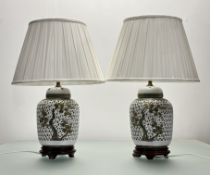 A pair of pierced white ceramic ginger jar table lamps, with green and gilt cherry blossom