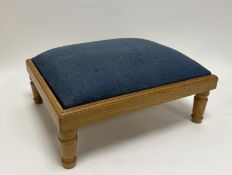 A modern wooden stained footstool with blue fabric upholstery raised on four peg feet (h. 17cm)