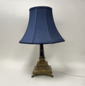 A Regency-style cast brass table lamp with blue handpainted gilt decorated column support, and