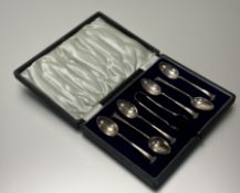 An Edwardian Sheffield silver set of six scroll terminal coffee spoons and set of tongs in