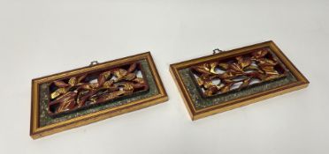 A pair of relief hand carved Chinese wooden wall panels with gilt wooden foliate decoration to