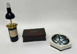 A Jersey Pottery ashtray with floral central design (d. 17cm), together with a wooden cigarette