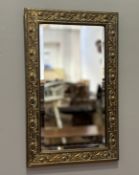 A 1920's Scottish embrossed Thistle bordered hall mirror with bevelled glass plate. (54cmx34cm)