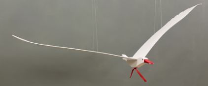 A hanging wooden puppet in the form of a white seabird with a red painted beak (w. 144cm)