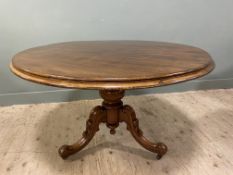 A Victorian mahogany centre table, with circular moulded tilt-top, raised on a carved column