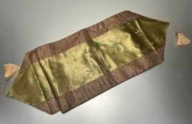 A modern Chinese silk embroidered tapestry/table runner decorated with urns and bamboo leaves on a