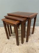 A modern inlaid mahogany and yew nest of tables, with crossbanded tops over square fluted supports