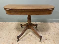 A Regency mahogany fold-over card table, the top opening to reveal green baize surface, on a