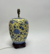 A Chinese porcelain enamelled ginger jar with cover, decorated with blue foliate detail and