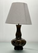 A Mid-Century Thai celadon glazed vase converted table lamp, raised on circular wooden base, with