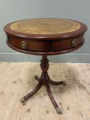 A reproduction mahogany drum table, with brown leather skiver to top, over two frieze drawers and