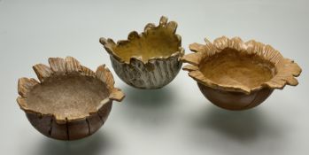 A collection of three comtemporary vessel pottery bowls, each in a naturalstic brown glaze with