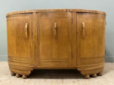 A 1930s oak bow-fronted sideboard, by E-Gomme (later G-Plan), the shaped top over three panel