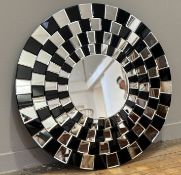 An Art Deco style circular hall mirror, with coloured black and mirror glass in geometric style