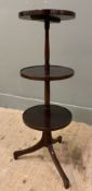 An reproduction mahogany Georgian-style dumb-waiter, with three-tier circular shelves raised on a