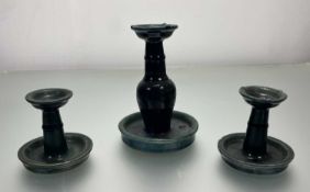 A pair of early 20thc Chinese 'Shiwan' short candleholders/oil lamps, with large drip trays and