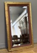 A Elizondo (Mexican) red and gilt wood distress framed hall mirror with bevelled glass panel. (