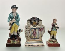 A group of Staffordshire figures, early 19th century comprising: a standing figure of a sportsman, a