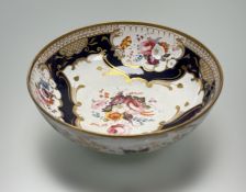 A 19th century porcelain centre bowl, possibly Coalport, painted with floral sprays within gilt