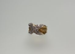 An 18ct gold and diamond pinky ring, the band centred by an X-form cross of diamond points mounted