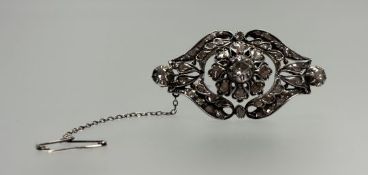 A diamond brooch, of shaped lozenge form, the central rose-cut diamond within a