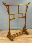 A modern Chinese pine traditional robe stand, with carved birds heads to top rail, on twin end and