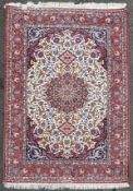 A hand-knotted Persian Isfahan rug, with large central medallion featuring lotus leaf and multiple