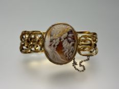 A 19th century carved shell cameo bracelet (unmarked), the oval cameo depicting Zeus, on a broad