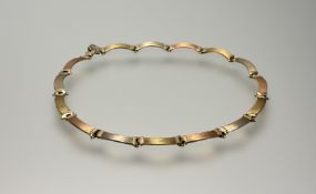 A 9ct bi-colour gold necklace, in rose and yellow gold, of brushed, curved plaque links, the clasp