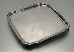 A George VI silver salver, Barker Brothers, Birmingham 1938, of shaped square form, raised on