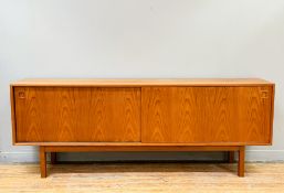 A Omann Jun A/S model no. 21 teak sideboard, the twin sliding doors with recessed handles, right