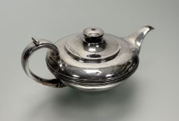 A George IV silver teapot, James Wintle, London 1825, of compressed circular form, the hinged