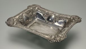 An Edwardian silver basket, Birmingham 1902, of rectangular form, the sides chased with c-scrolls,