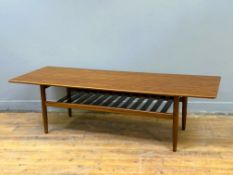 A 1960s/70s G Plan teak long coffee table with slatted undertier, on tapered supports (h.46cm x l.