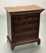 A George II style walnut miniature chest of drawers, early 20th century, the moulded crossbanded top