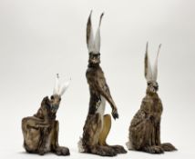 Jeremy James (British b. 1964), a group of three stoneware sculptures of hares, modelled in