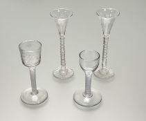 An etched and cut wine glass, the ogee bowl decorated with vine leaves and an insect, on an opaque