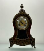 A Boulle mantel clock in the Rococo taste, c. 1900, the embossed gilt dial with ceramic Roman