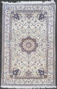 A Persian Nain rug, with ornate scrolling central medallion surrounded by vines and flowerheads,