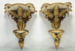 A pair of mid-19th century giltwood and gilt-composition two-tier wall brackets, each with scalloped