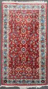 A hand-knotted Macedonian Saruh rug, central field with stylized flowerhead and leaf motifs,